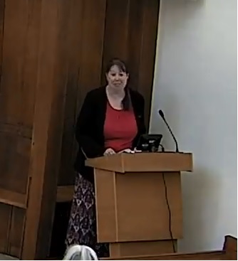 Kate speaking at a lectern